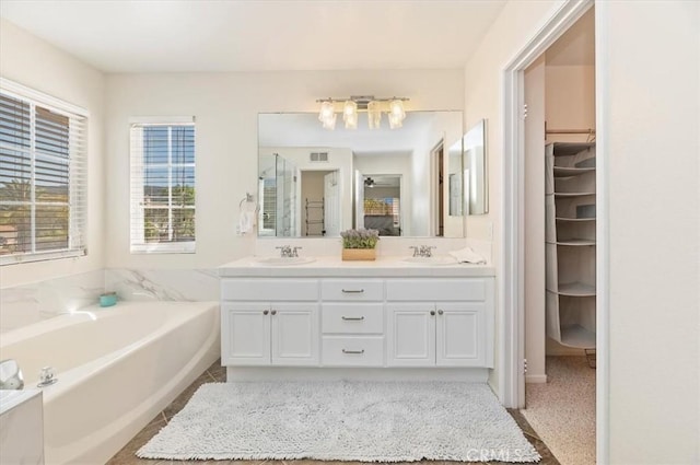 24320 Calle Estancia, Murrieta, CA 92562 - bathroom with double vanity, a bath, and a spacious closet