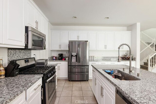 706 Leather Oak Ln, Pomona, CA 91766 - kitchen with appliances with stainless steel finishes, a sink, white cabinets, and recessed lighting