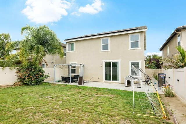 706 Leather Oak Ln, Pomona, CA 91766 - back of house featuring a patio area, stucco siding, and roof mounted solar panels