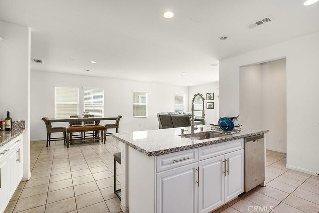 706 Leather Oak Ln, Pomona, CA 91766 - kitchen featuring stainless steel dishwasher, a sink, light tile patterned floors, white cabinets, and recessed lighting