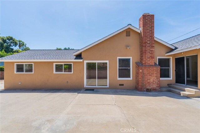 404 N Pear Knl, Anaheim, CA 92805 - back of house featuring stucco siding, a shingled roof, a patio area, and a chimney