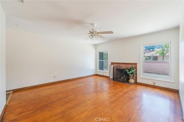 404 N Pear Knl, Anaheim, CA 92805 - unfurnished living room with healthy amount of natural light, light wood-style floors, baseboards, and a fireplace