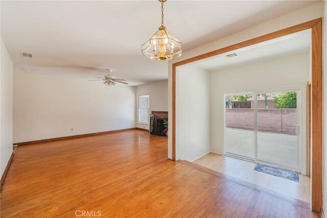 404 N Pear Knl, Anaheim, CA 92805 - unfurnished room with a chandelier, light wood-type flooring, and a ceiling fan