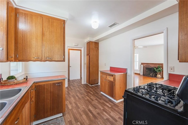 404 N Pear Knl, Anaheim, CA 92805 - kitchen with black range with gas stovetop, brown cabinets, and dark wood-style floors
