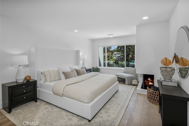 22526 Lake Forest Ln, Lake Forest, CA 92630 - bedroom with a multi sided fireplace, recessed lighting, and light wood finished floors