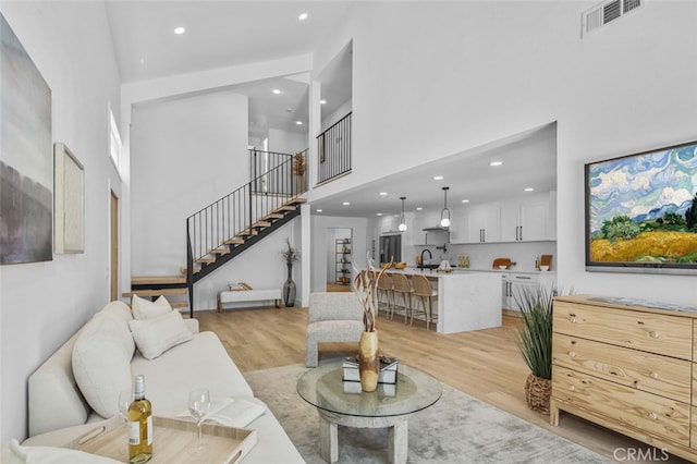 22526 Lake Forest Ln, Lake Forest, CA 92630 - living area featuring a high ceiling, light wood-style flooring, stairway, and recessed lighting