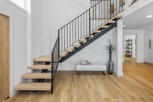 22526 Lake Forest Ln, Lake Forest, CA 92630 - stairway with wood finished floors, a high ceiling, and recessed lighting