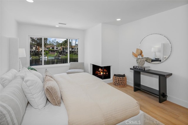 22526 Lake Forest Ln, Lake Forest, CA 92630 - bedroom featuring recessed lighting, wood finished floors, a multi sided fireplace, and a water view