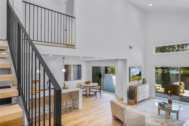 22526 Lake Forest Ln, Lake Forest, CA 92630 - living room with a towering ceiling, stairway, wood finished floors, plenty of natural light, and recessed lighting
