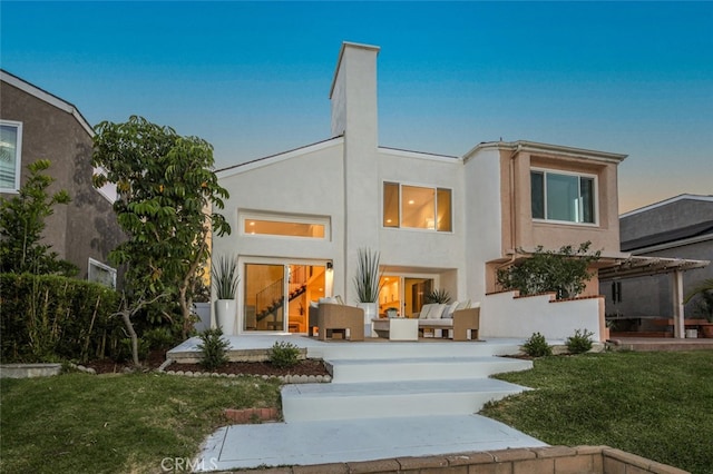 22526 Lake Forest Ln, Lake Forest, CA 92630 - rear view of house featuring stucco siding, an outdoor living space, a lawn, and a patio