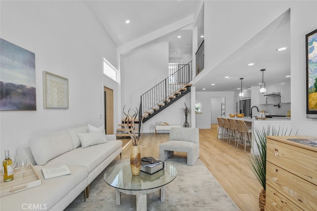 22526 Lake Forest Ln, Lake Forest, CA 92630 - living room featuring stairs, a towering ceiling, light wood finished floors, recessed lighting, and plenty of natural light