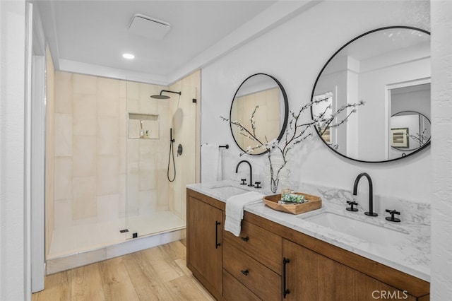 22526 Lake Forest Ln, Lake Forest, CA 92630 - full bath with double vanity, a tile shower, and wood finished floors