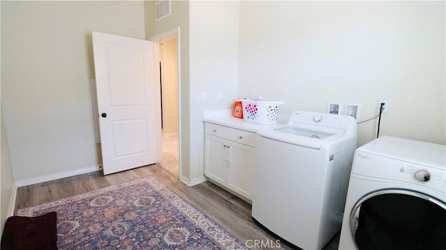 27506 Aster Way, Saugus, CA 91350 - laundry room with washing machine and clothes dryer, light wood finished floors, cabinet space, and baseboards