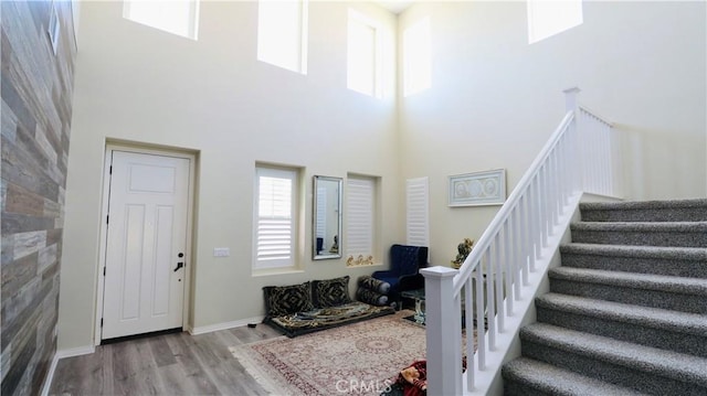 27506 Aster Way, Saugus, CA 91350 - foyer featuring a towering ceiling, wood finished floors, stairway, and baseboards