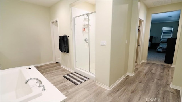 27506 Aster Way, Saugus, CA 91350 - bathroom with wood finished floors, a shower stall, baseboards, and a bath