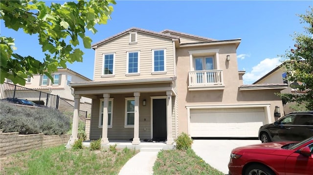 27506 Aster Way, Saugus, CA 91350 - traditional home featuring a porch, an attached garage, concrete driveway, stucco siding, and a balcony