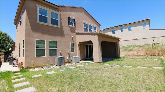 27506 Aster Way, Saugus, CA 91350 - rear view of house featuring stucco siding, central air condition unit, and a patio
