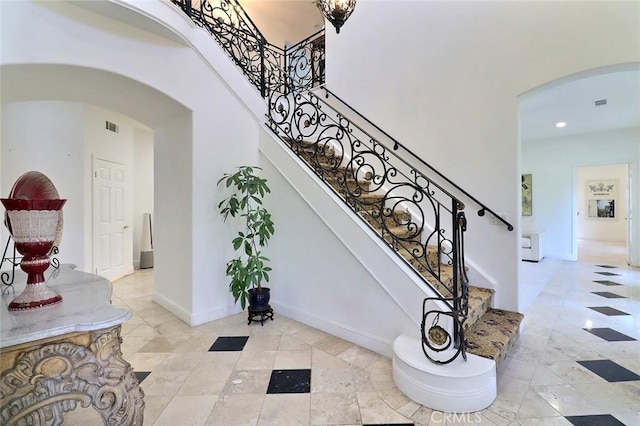 8424 Sunnyslope Dr, San Gabriel, CA 91775 - stairs with arched walkways, a high ceiling, recessed lighting, baseboards, and tile patterned flooring