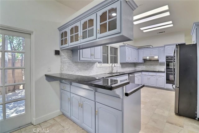 8424 Sunnyslope Dr, San Gabriel, CA 91775 - kitchen featuring stainless steel appliances, a peninsula, under cabinet range hood, decorative backsplash, and a sink