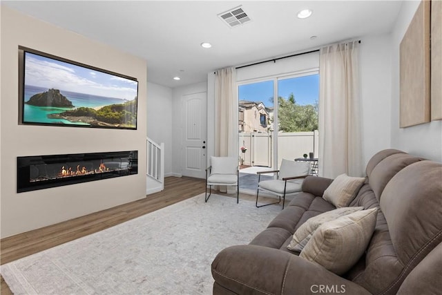 1733 San Eugenio, San Diego, CA 92154 - living area featuring wood finished floors, recessed lighting, and a glass covered fireplace