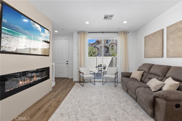 1733 San Eugenio, San Diego, CA 92154 - living room featuring wood finished floors, recessed lighting, and a glass covered fireplace