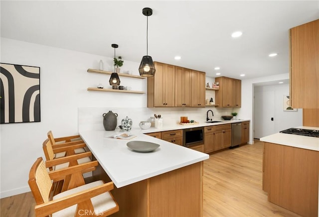 230 Gila Way, Placentia, CA 92870 - kitchen featuring open shelves, a sink, a peninsula, stainless steel appliances, and a kitchen breakfast bar