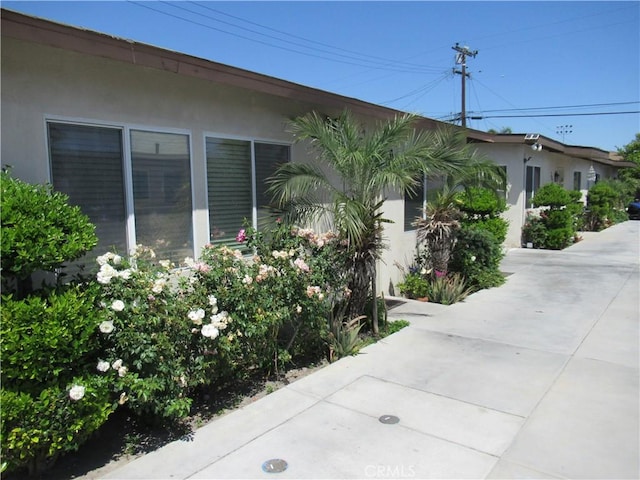 7010 Granger Ave, Bell Gardens, CA 90201 - view of side of home featuring stucco siding
