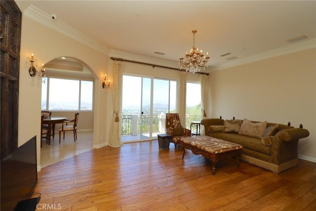 485 Kathleen Dr, Newbury Park, CA 91320 - living room featuring a chandelier, arched walkways, light wood finished floors, crown molding, and baseboards