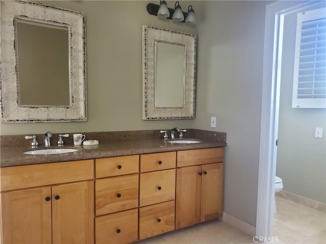485 Kathleen Dr, Newbury Park, CA 91320 - bathroom with double vanity, toilet, baseboards, and tile patterned floors