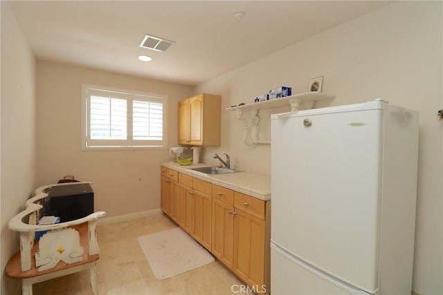 485 Kathleen Dr, Newbury Park, CA 91320 - kitchen with fridge, a sink, light brown cabinets, light countertops, and baseboards