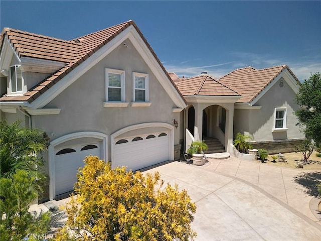 485 Kathleen Dr, Newbury Park, CA 91320 - view of front of house featuring stucco siding, a garage, a tile roof, and driveway