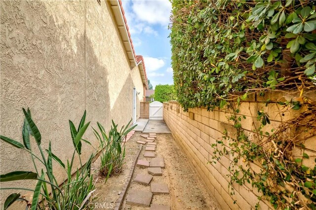 2501 Tiffany Pl, Fullerton, CA 92833 - view of home's exterior featuring stucco siding and a gate