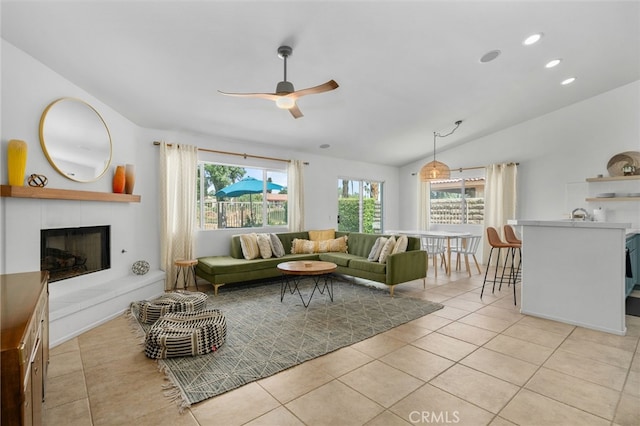 49239 Barrymore St, Indio, CA 92201 - living room with a tiled fireplace, a ceiling fan, vaulted ceiling, light tile patterned floors, and recessed lighting