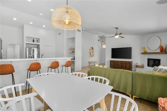49239 Barrymore St, Indio, CA 92201 - dining room featuring built in shelves, a ceiling fan, recessed lighting, and a glass covered fireplace