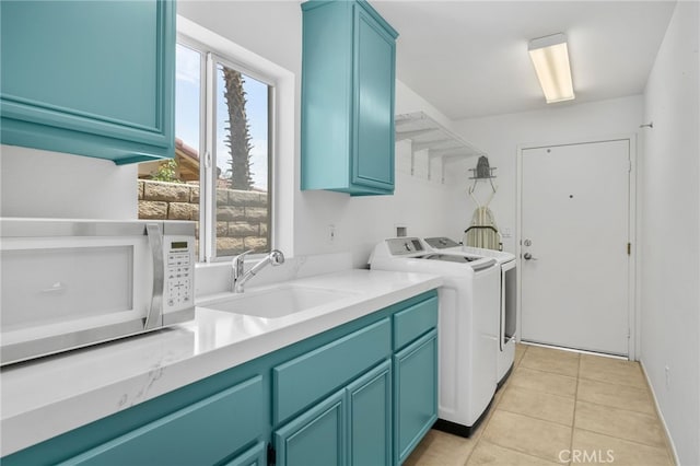49239 Barrymore St, Indio, CA 92201 - washroom featuring washing machine and dryer, cabinet space, and light tile patterned floors