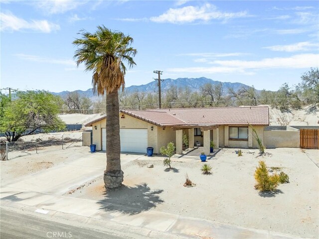 27525 Ventura Dr, Cathedral City, CA 92234 - view of front of house featuring stucco siding, an attached garage, a tiled roof, a mountain view, and driveway