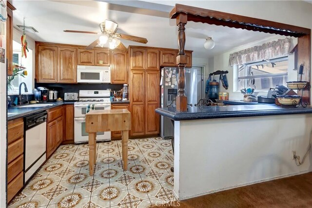24812 Calle El Toro Grande, Lake Forest, CA 92630 - kitchen with white appliances, a sink, ceiling fan, dark countertops, and a peninsula