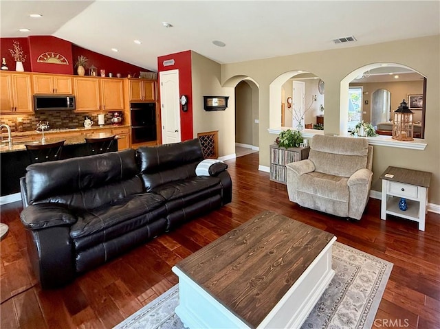 757 Onstott Rd, Lompoc, CA 93436 - living room with dark wood-type flooring, lofted ceiling, arched walkways, and baseboards