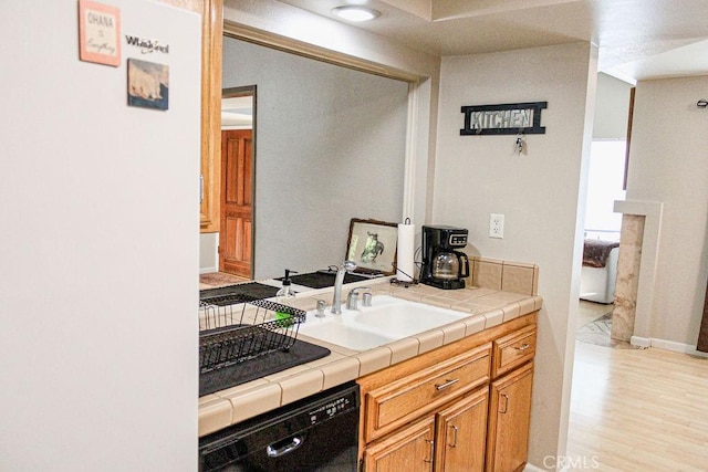 915 Moran Ct, Paso Robles, CA 93446 - kitchen with black dishwasher, light wood-style floors, a sink, and tile counters