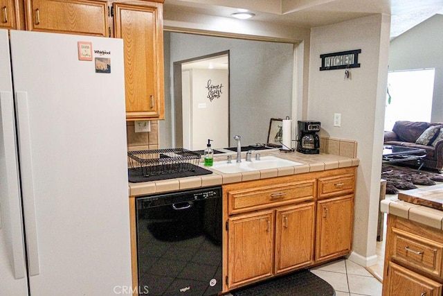 915 Moran Ct, Paso Robles, CA 93446 - kitchen with black dishwasher, freestanding refrigerator, light tile patterned floors, a sink, and tile countertops