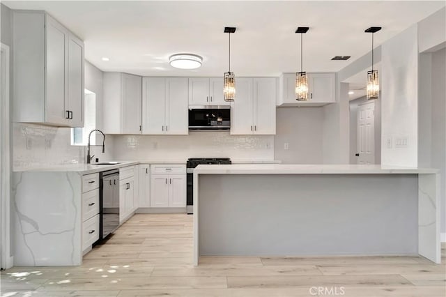 7741 Shoup Ave, West Hills, CA 91304 - kitchen featuring stainless steel appliances, a sink, light wood-style floors, decorative backsplash, and recessed lighting