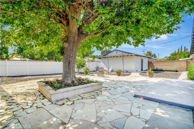 7741 Shoup Ave, West Hills, CA 91304 - fenced backyard with a patio area and an outbuilding