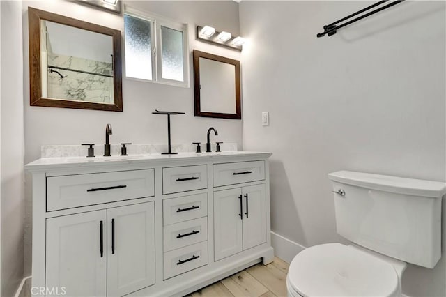 7741 Shoup Ave, West Hills, CA 91304 - bathroom with toilet, double vanity, baseboards, a shower, and wood finished floors