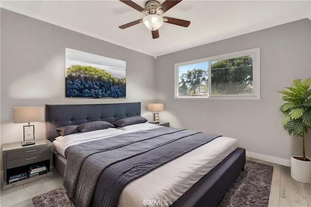 7741 Shoup Ave, West Hills, CA 91304 - bedroom with light wood-style flooring, a ceiling fan, and baseboards