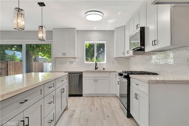 7741 Shoup Ave, West Hills, CA 91304 - kitchen with appliances with stainless steel finishes, a sink, backsplash, light wood-style flooring, and recessed lighting