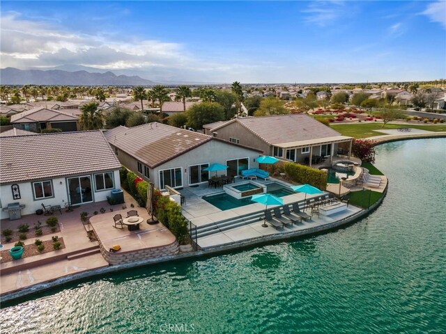 84260 Tramonto Way, Indio, CA 92203 - view of pool with a residential view, a pool with connected hot tub, a patio, a fire pit, and a water and mountain view