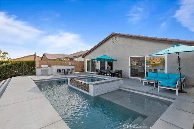 84260 Tramonto Way, Indio, CA 92203 - view of swimming pool featuring an outdoor kitchen, a patio, a pool with connected hot tub, and outdoor lounge area