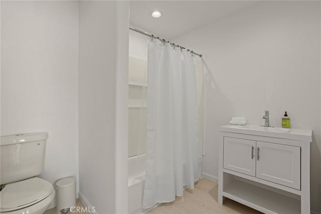 84260 Tramonto Way, Indio, CA 92203 - bathroom featuring toilet, baseboards, shower / bath combo with shower curtain, wood finished floors, and vanity