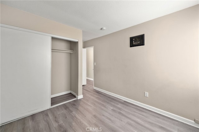 4137 Tiberon Dr, Oceanside, CA 92056 - unfurnished bedroom with wood finished floors, a closet, and baseboards