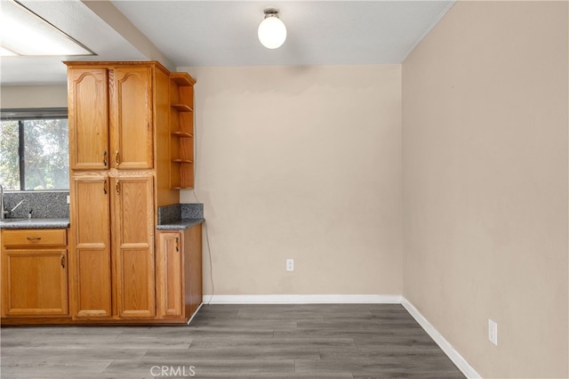 4137 Tiberon Dr, Oceanside, CA 92056 - kitchen with open shelves, wood finished floors, brown cabinets, and baseboards